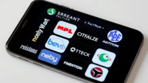 Multiple streaming service logos displayed on a smartphone screen showing various platforms side by side, representing streaming fragmentation and aggregation concept