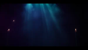 Moody atmospheric film still showing candlelit shadows and mystical fog, cinematic horror aesthetic, dark purple and green tones, mysterious theatrical lighting, no faces or text visible, cinematic composition